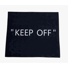 Black door rug with "KEEP OFF"