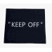 Black door rug with "KEEP OFF"